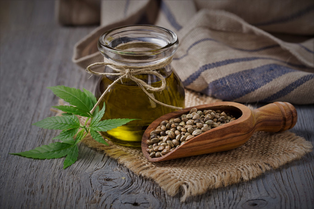 Hemp oil glass jar and hemp seeds